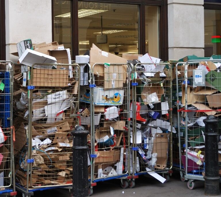 trolly full of folded cardboard waste in retail shop